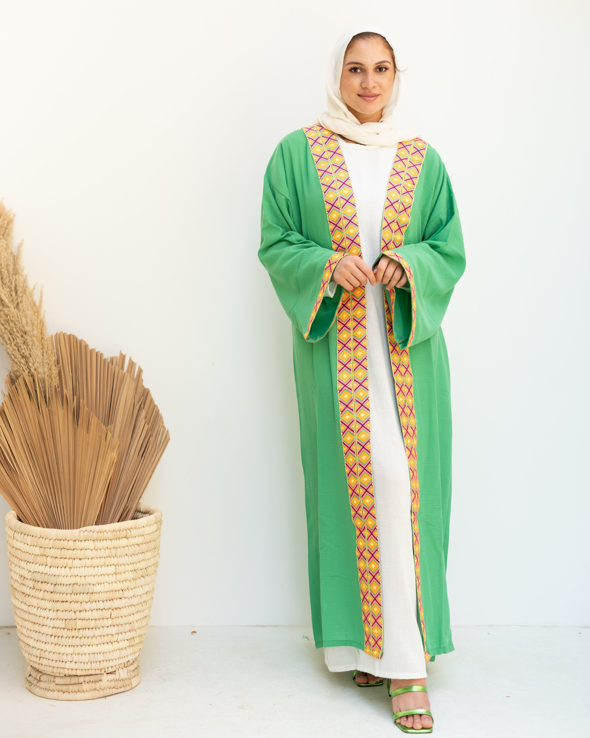 Green cloak with zigzag tape