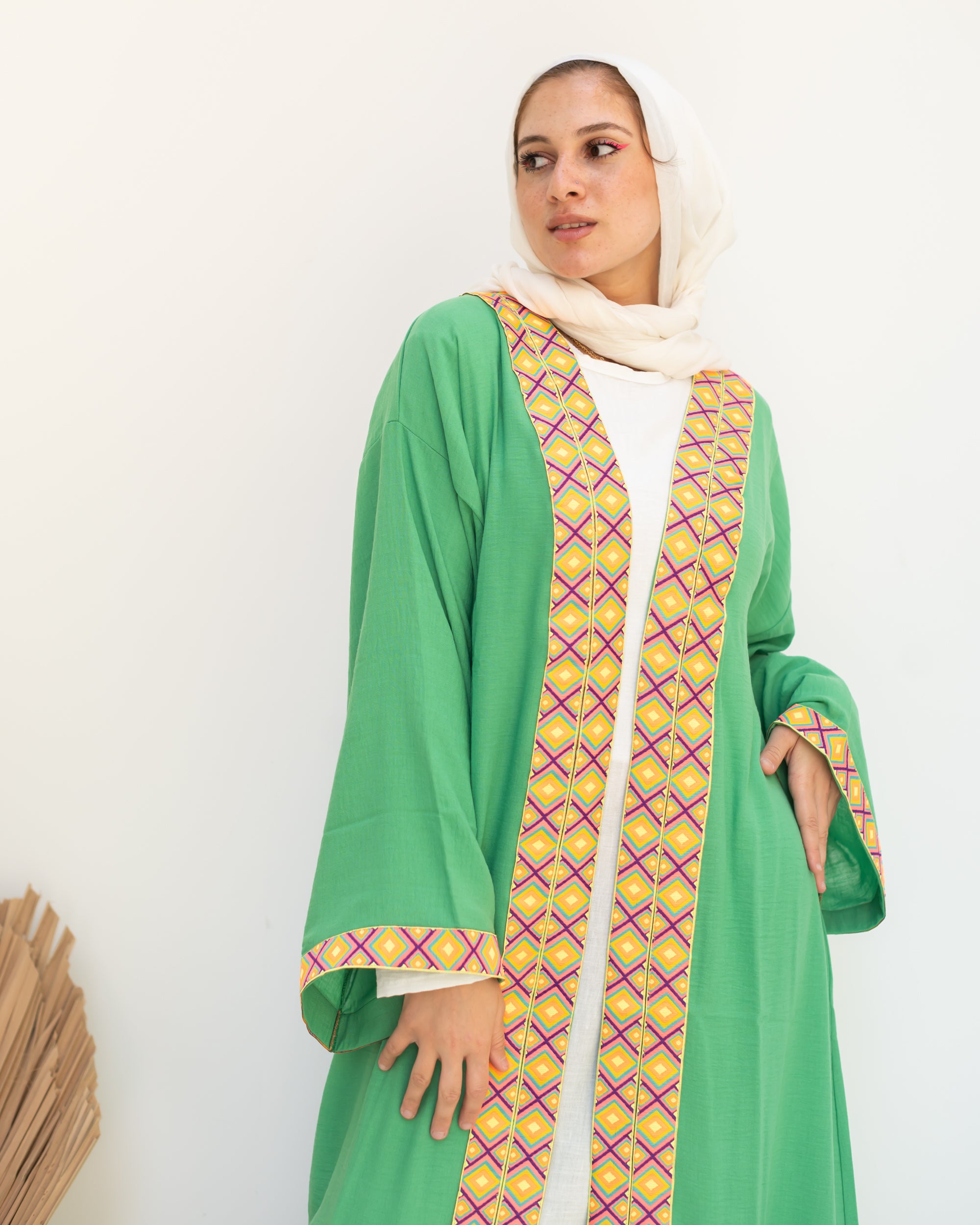 Green cloak with zigzag tape